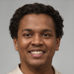 Joyful latino young-adult male with short  brown hair and brown eyes