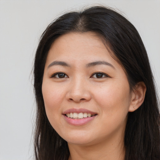 Joyful asian young-adult female with long  brown hair and brown eyes