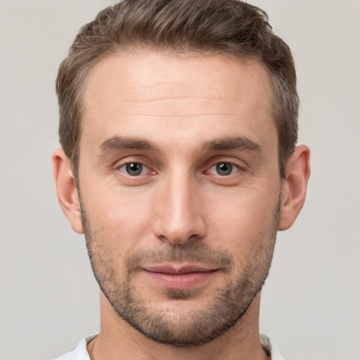 Joyful white young-adult male with short  brown hair and brown eyes