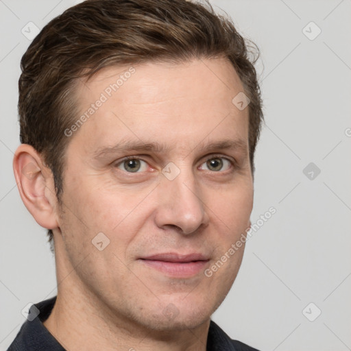 Joyful white adult male with short  brown hair and grey eyes