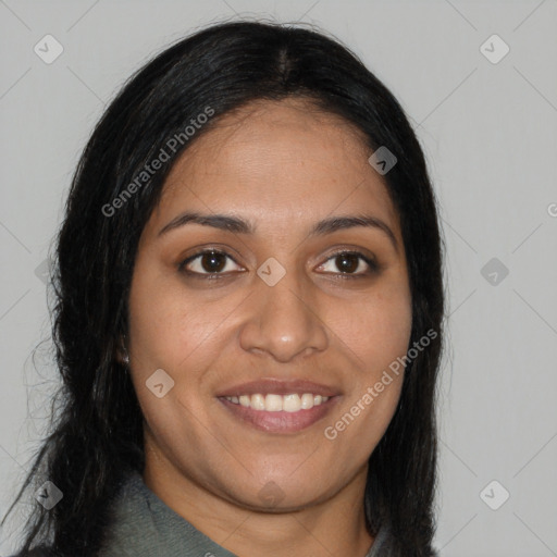 Joyful black young-adult female with long  brown hair and brown eyes