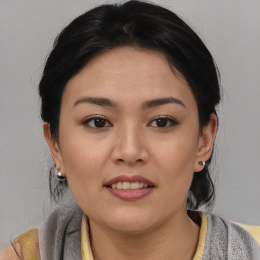 Joyful asian young-adult female with medium  black hair and brown eyes