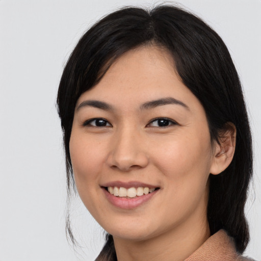 Joyful asian young-adult female with medium  black hair and brown eyes