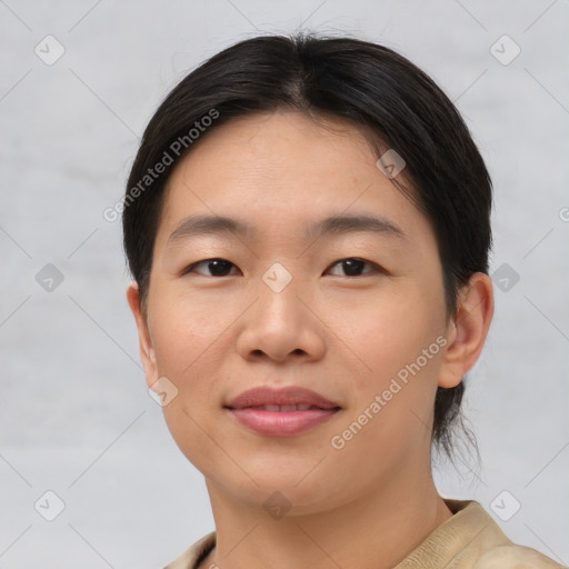 Joyful asian young-adult female with short  brown hair and brown eyes