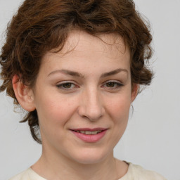 Joyful white young-adult female with medium  brown hair and green eyes