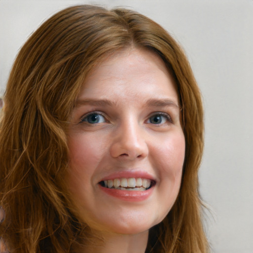 Joyful white young-adult female with long  brown hair and blue eyes