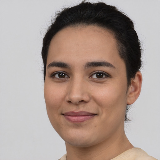 Joyful latino young-adult female with short  brown hair and brown eyes