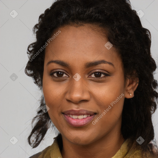 Joyful black young-adult female with long  black hair and brown eyes