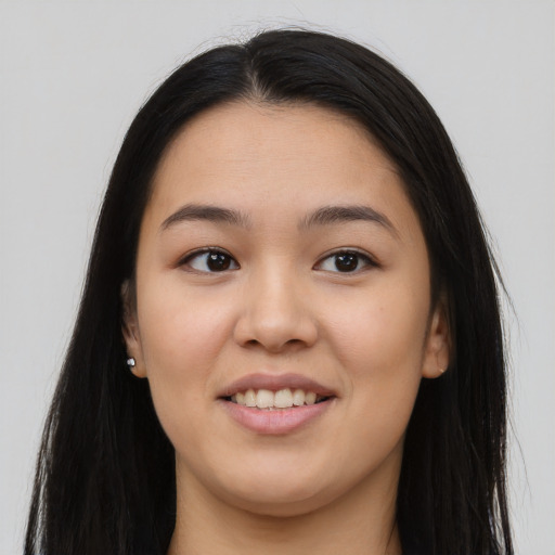 Joyful asian young-adult female with long  brown hair and brown eyes
