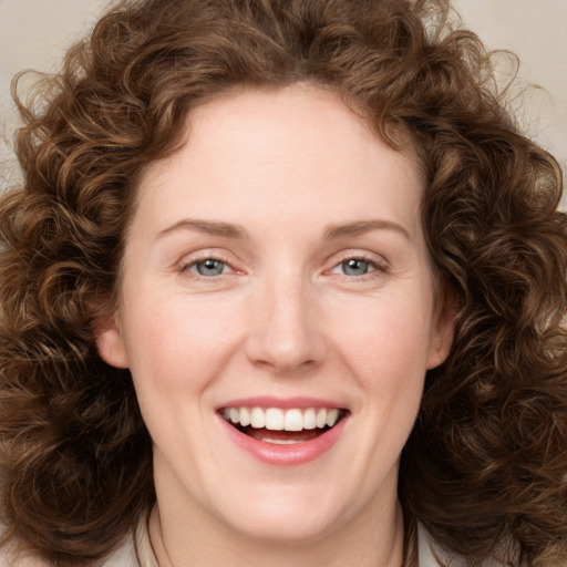 Joyful white young-adult female with medium  brown hair and green eyes