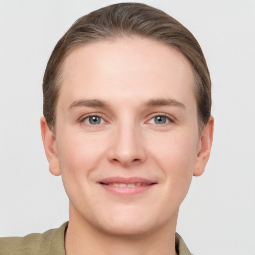 Joyful white young-adult female with short  brown hair and grey eyes