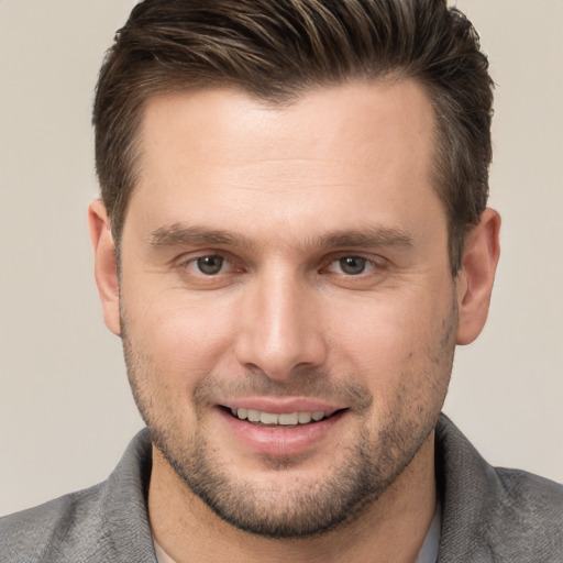 Joyful white young-adult male with short  brown hair and brown eyes