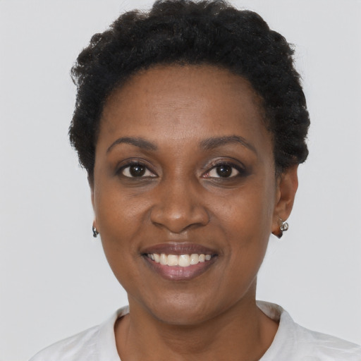 Joyful black adult female with short  black hair and brown eyes