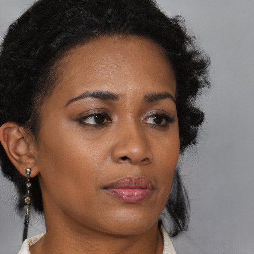 Neutral black young-adult female with medium  brown hair and brown eyes