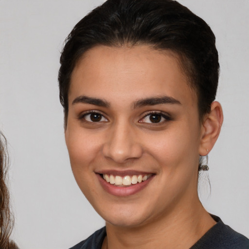 Joyful white young-adult female with medium  brown hair and brown eyes