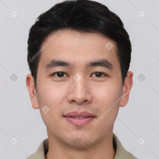 Joyful asian young-adult male with short  black hair and brown eyes