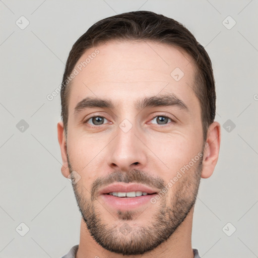 Joyful white young-adult male with short  brown hair and brown eyes