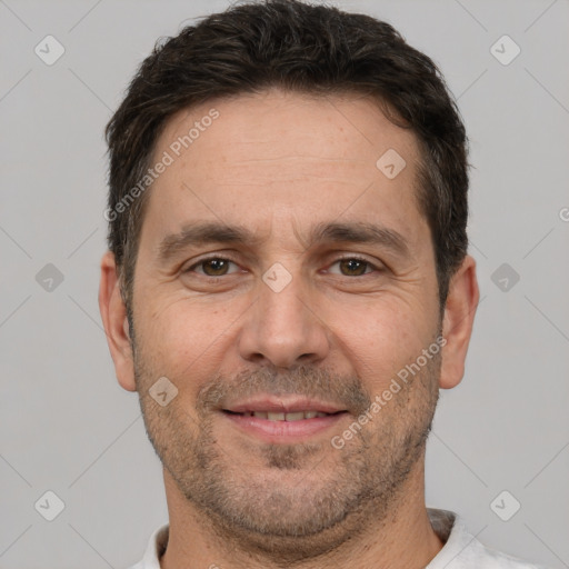 Joyful white adult male with short  brown hair and brown eyes