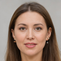 Joyful white adult female with long  brown hair and brown eyes