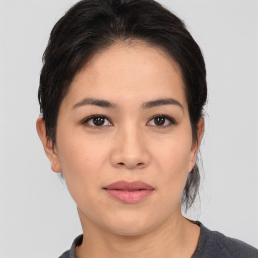 Joyful white young-adult female with medium  brown hair and brown eyes