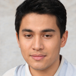 Joyful latino young-adult male with short  brown hair and brown eyes