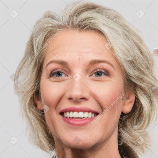 Joyful white adult female with medium  brown hair and blue eyes