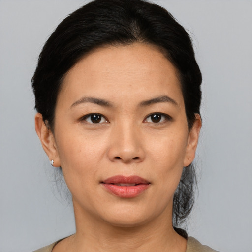 Joyful asian adult female with medium  black hair and brown eyes