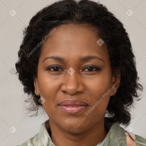 Joyful black adult female with medium  brown hair and brown eyes