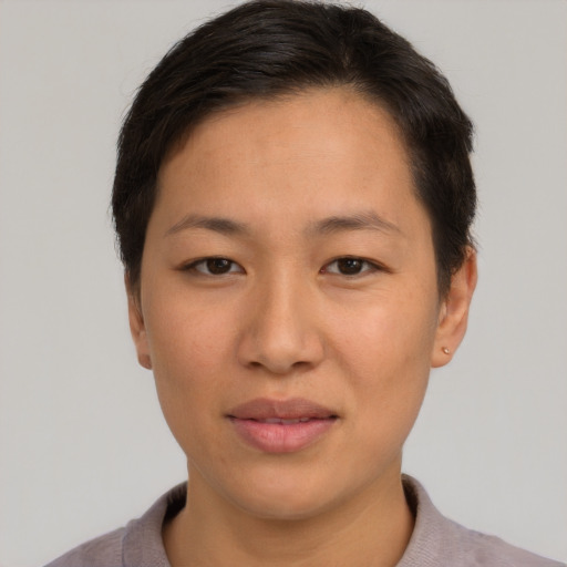 Joyful asian adult female with short  brown hair and brown eyes