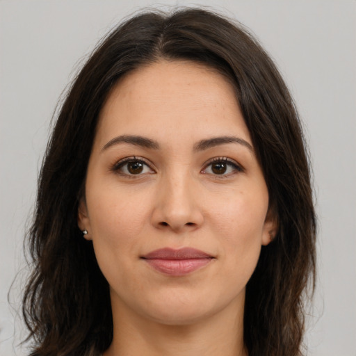 Joyful white young-adult female with long  brown hair and brown eyes