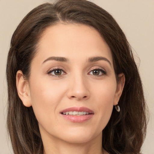 Joyful white young-adult female with long  brown hair and brown eyes