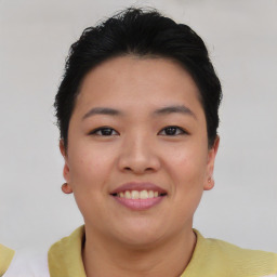 Joyful asian young-adult female with short  brown hair and brown eyes