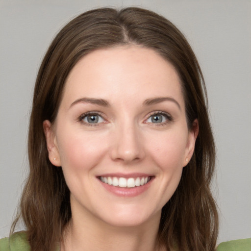 Joyful white young-adult female with medium  brown hair and green eyes