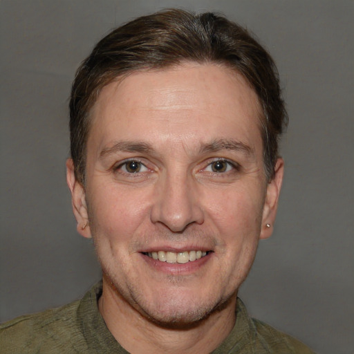 Joyful white adult male with short  brown hair and brown eyes