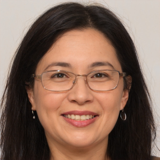 Joyful white adult female with long  brown hair and brown eyes