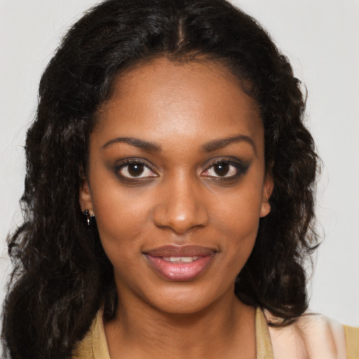 Joyful black young-adult female with medium  brown hair and brown eyes