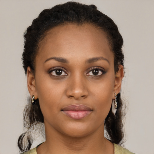 Joyful black young-adult female with short  black hair and brown eyes
