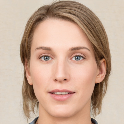 Joyful white young-adult female with medium  brown hair and blue eyes