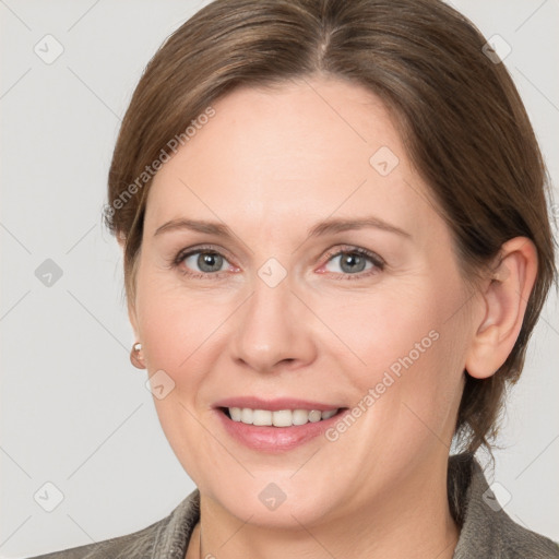 Joyful white adult female with medium  brown hair and grey eyes