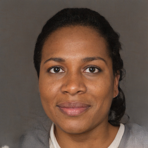 Joyful black adult female with short  black hair and brown eyes