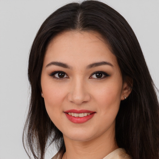 Joyful asian young-adult female with long  brown hair and brown eyes