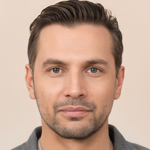 Joyful white young-adult male with short  brown hair and brown eyes