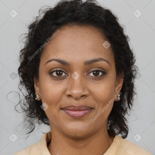 Joyful black adult female with long  brown hair and brown eyes