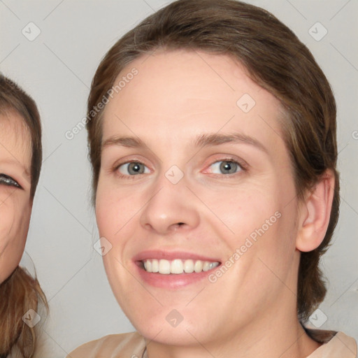 Joyful white young-adult female with medium  brown hair and blue eyes