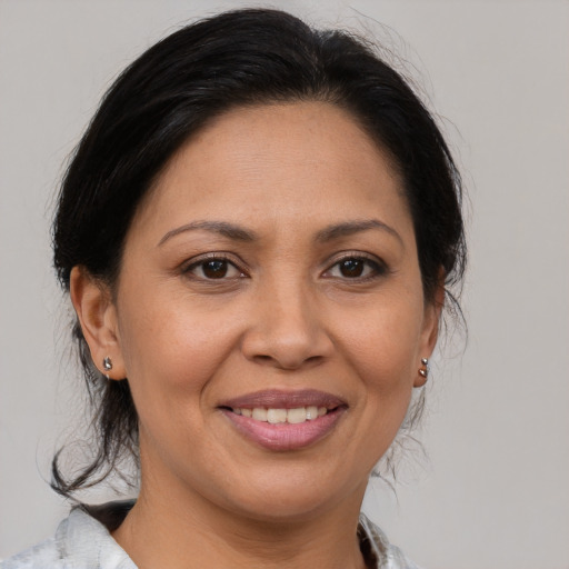 Joyful white adult female with medium  brown hair and brown eyes