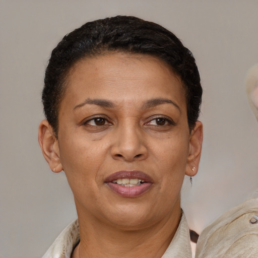Joyful latino adult female with short  brown hair and brown eyes