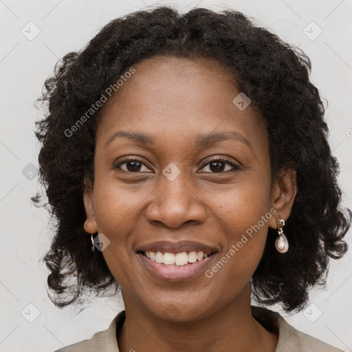 Joyful black adult female with medium  brown hair and brown eyes