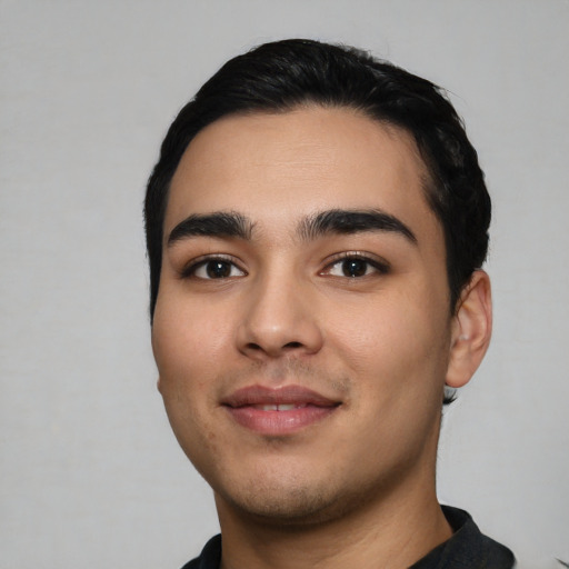 Joyful latino young-adult male with short  black hair and brown eyes