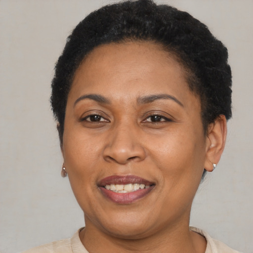 Joyful latino adult female with short  brown hair and brown eyes