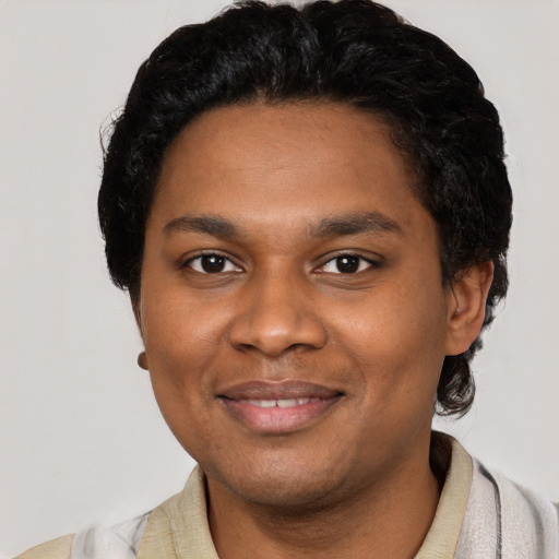Joyful black young-adult male with short  black hair and brown eyes